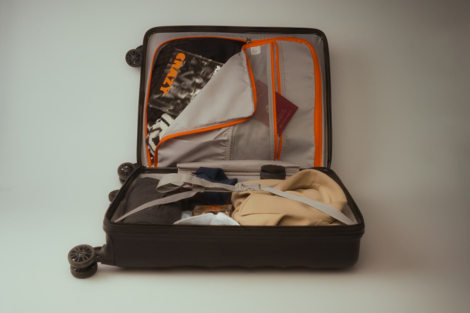 Luxury travel toiletry kit packed in an open carry-on suitcase ready for a trip
