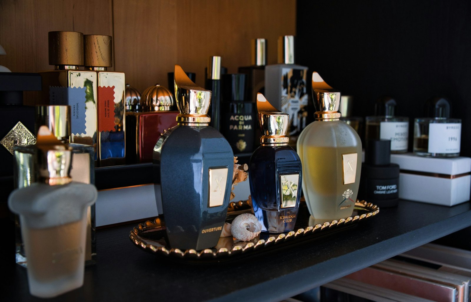 Luxury perfume for women long lasting: a collection of designer perfume bottles on a gold vanity tray