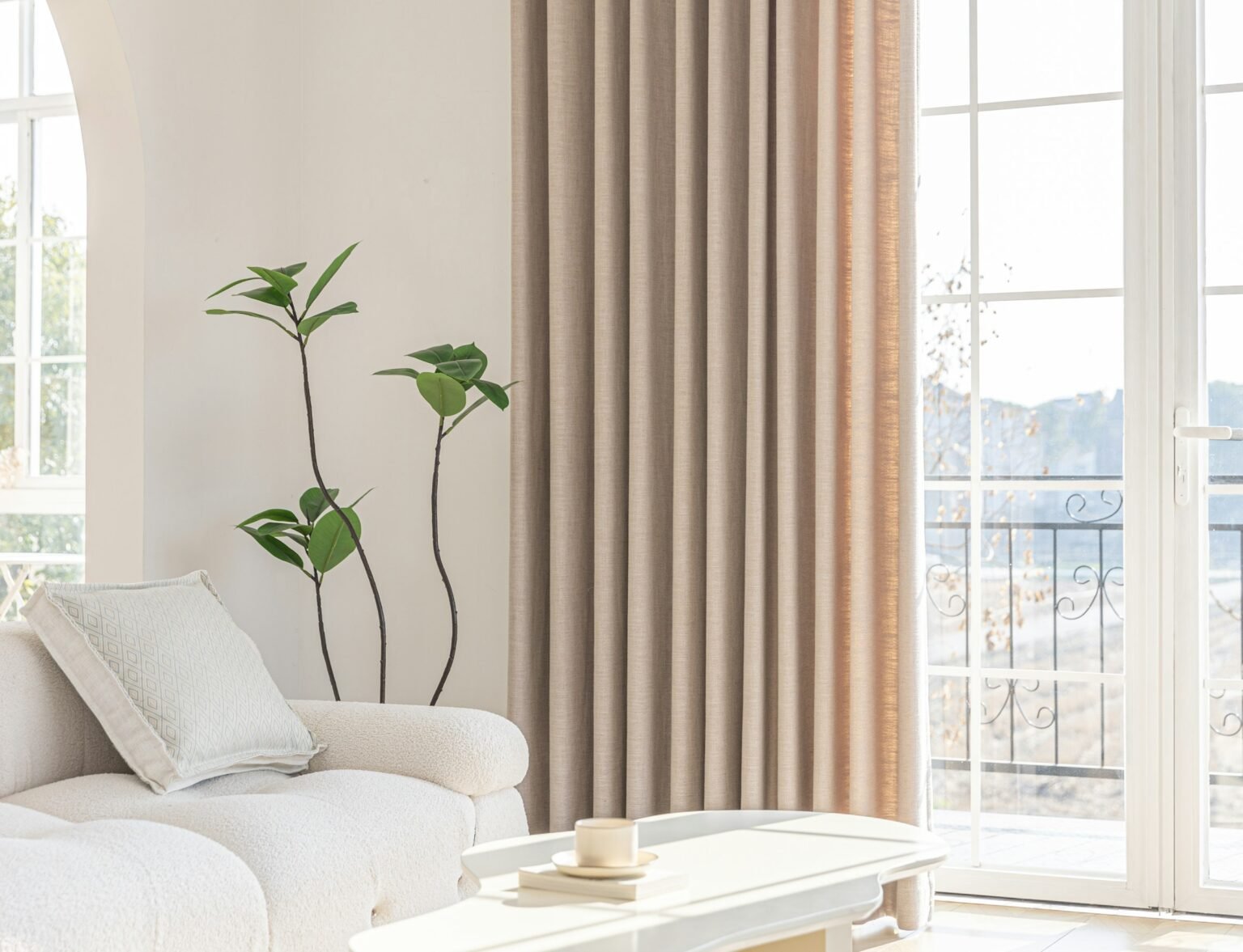 Pinch pleat curtains styling idea: a bright living room with neutral curtains