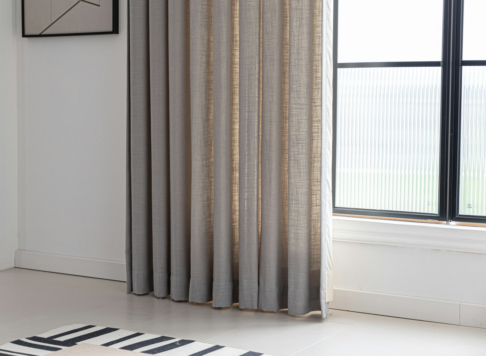 Pinch pleat curtains style: natural linen curtains framing a bright window