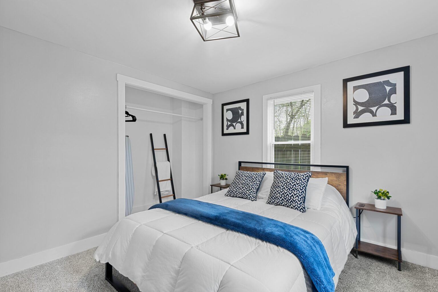 Queen quilt set style idea: a white bed with a blue blanket in a bright bedroom