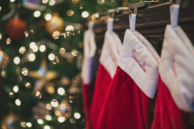 Stocking stuffers for teen girls: personalized red and white Christmas stockings hanging by the tree