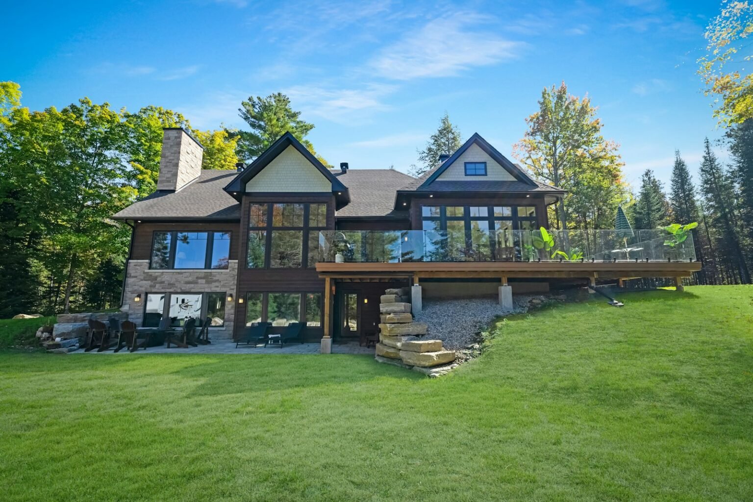 House with a raised deck overlooking a lawn