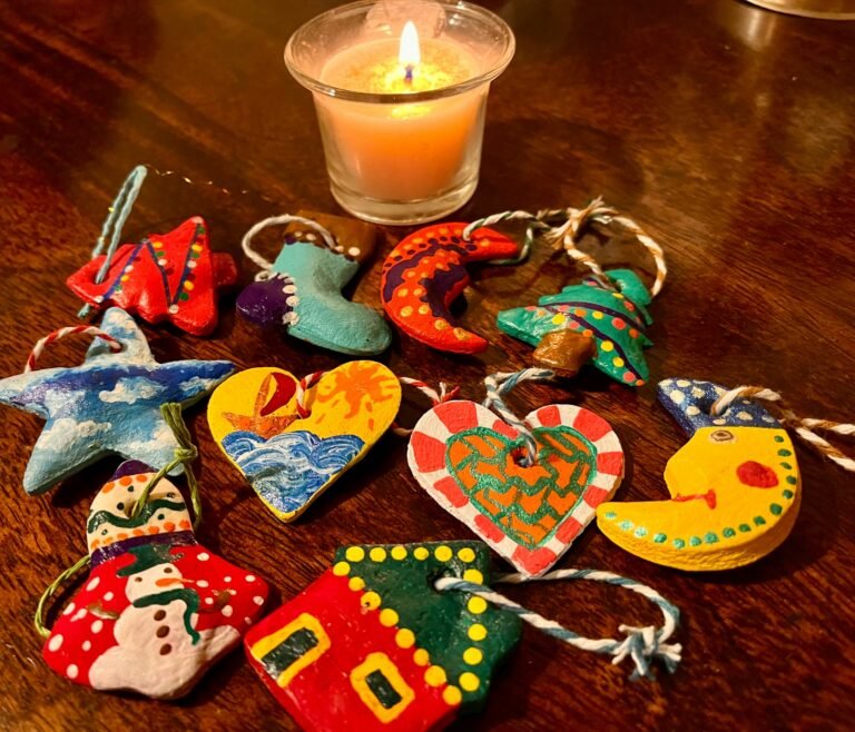 Handmade Christmas ornaments and a lit candle