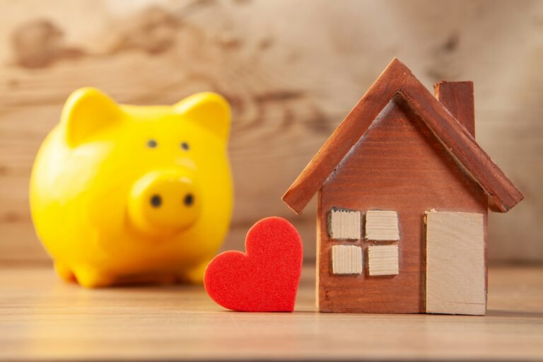 Yellow piggy bank with a wooden house