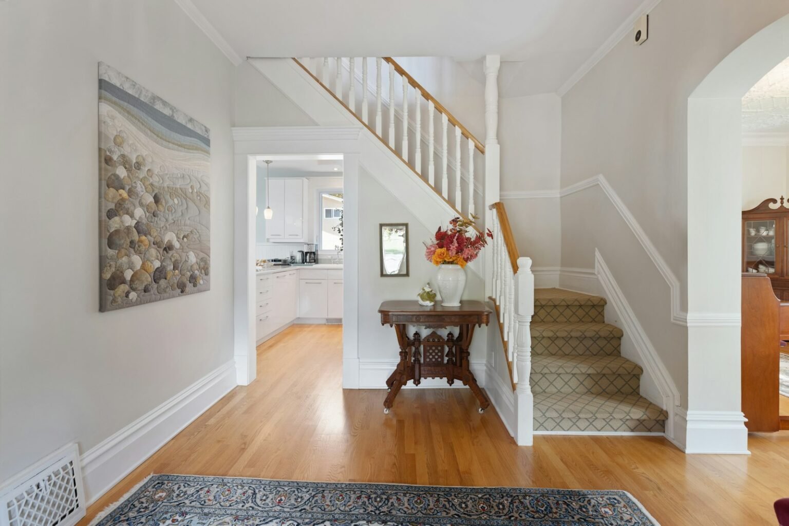 Hallway with a wood floor and a painting