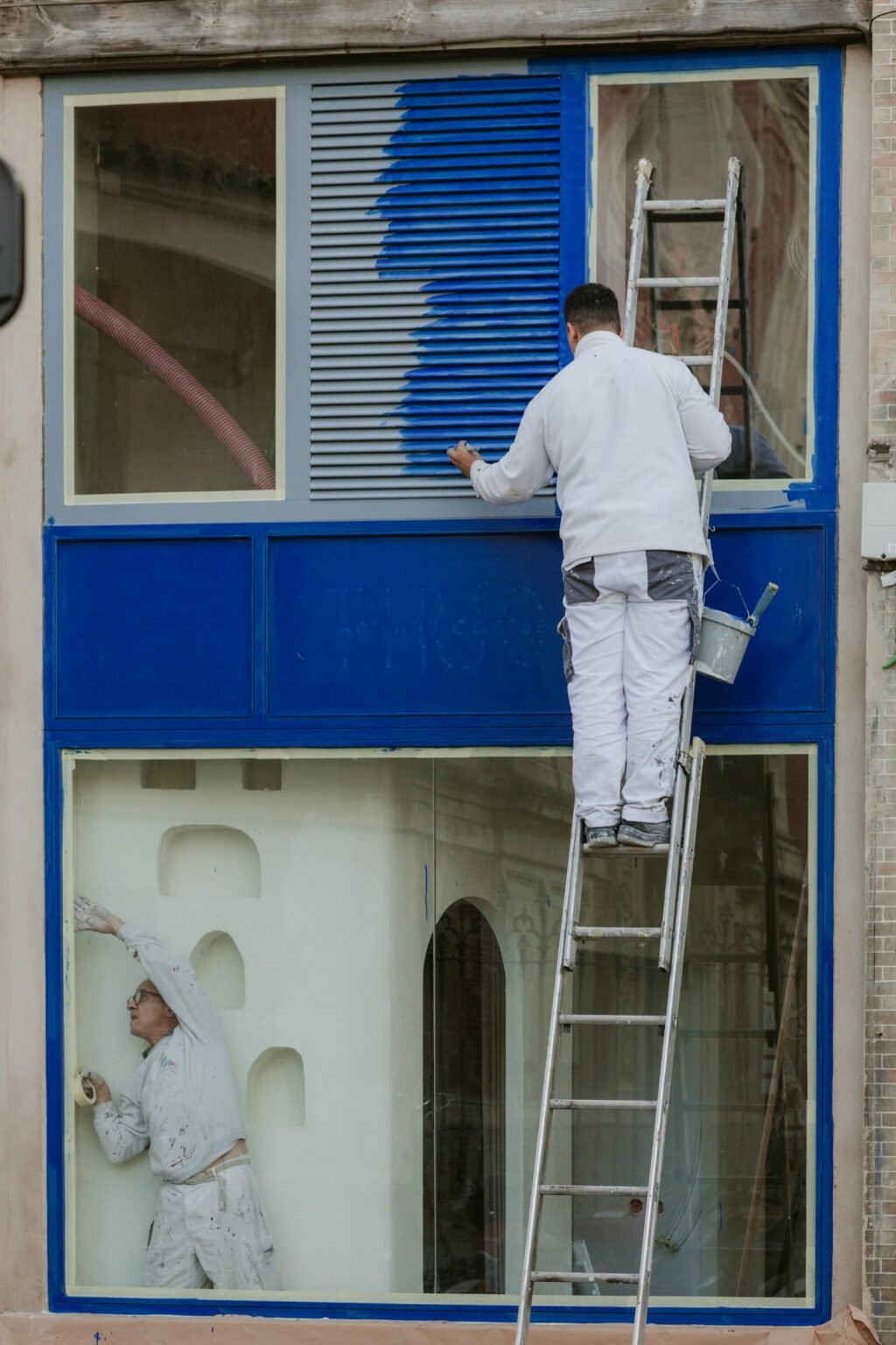 Painter on a ladder at a window