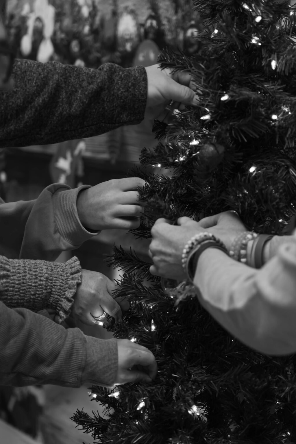 People putting decorations on a Christmas tree