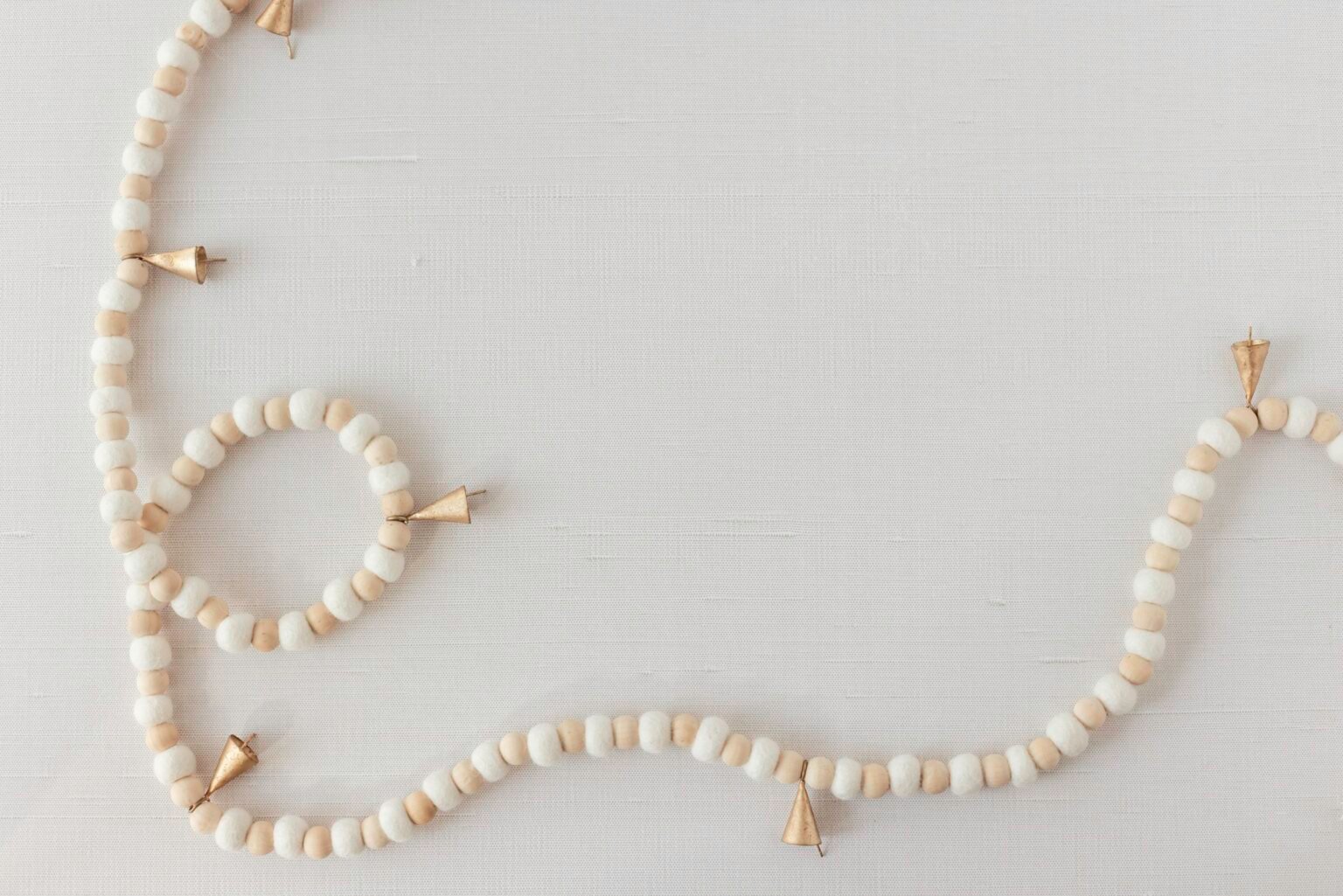 Beaded garland with small golden bells