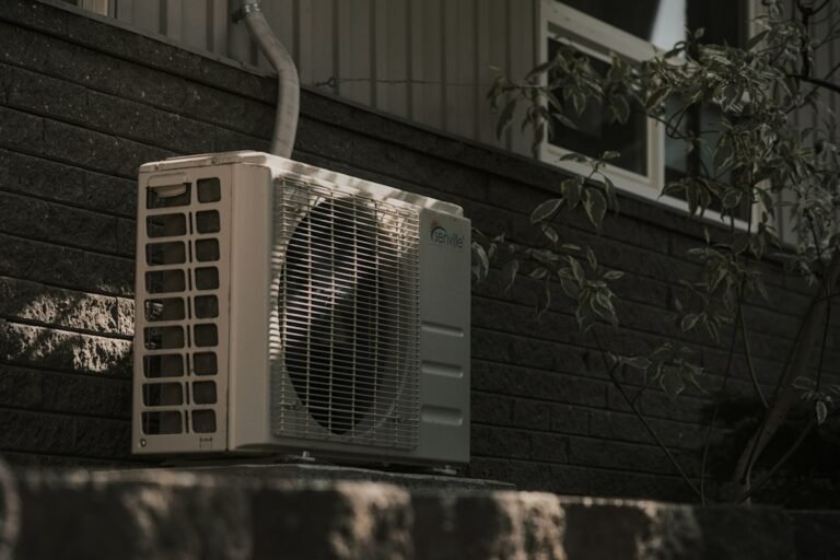 Outdoor air conditioner unit next to a house