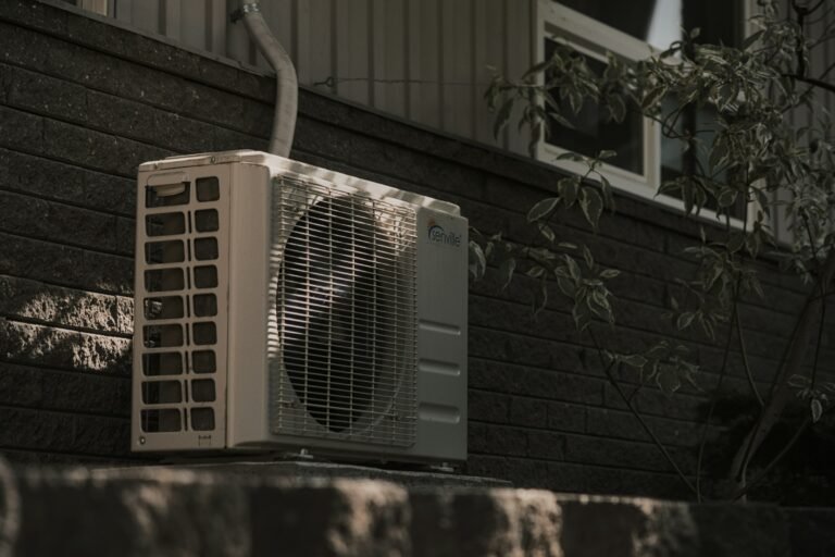 Outdoor air conditioner unit next to a house