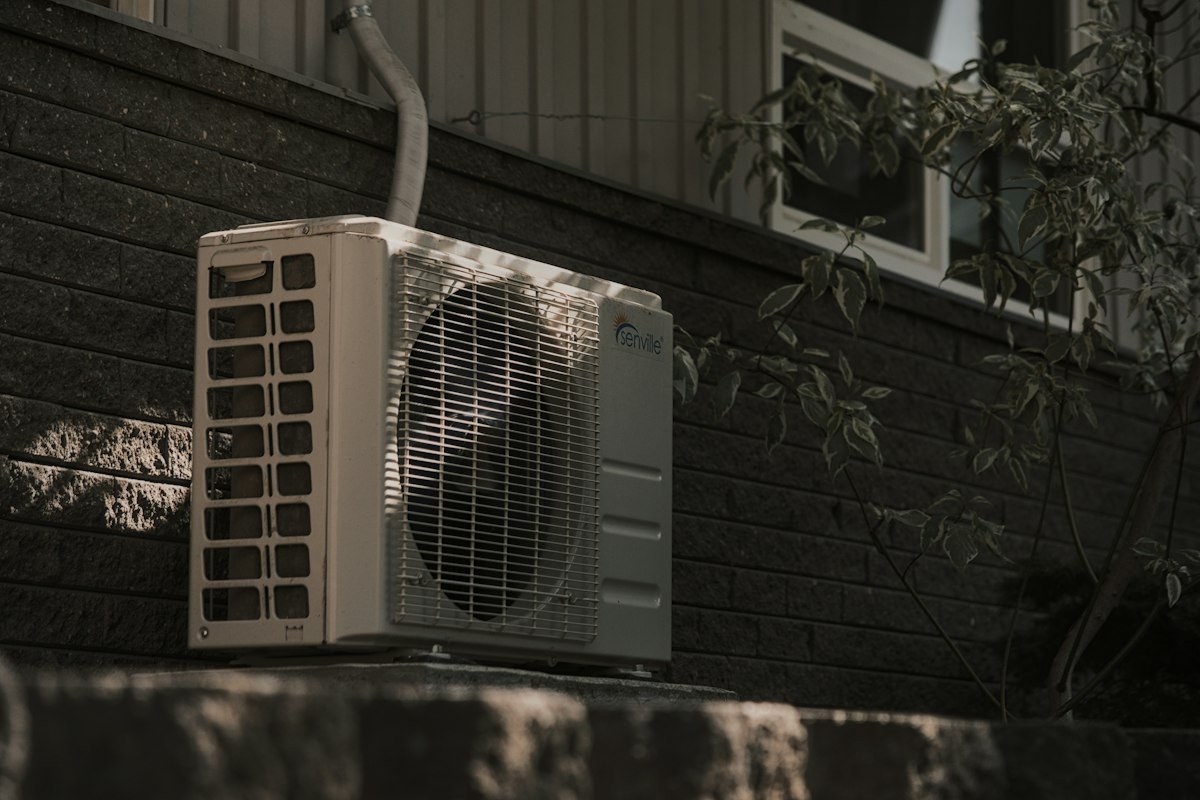 Outdoor air conditioner unit next to a house