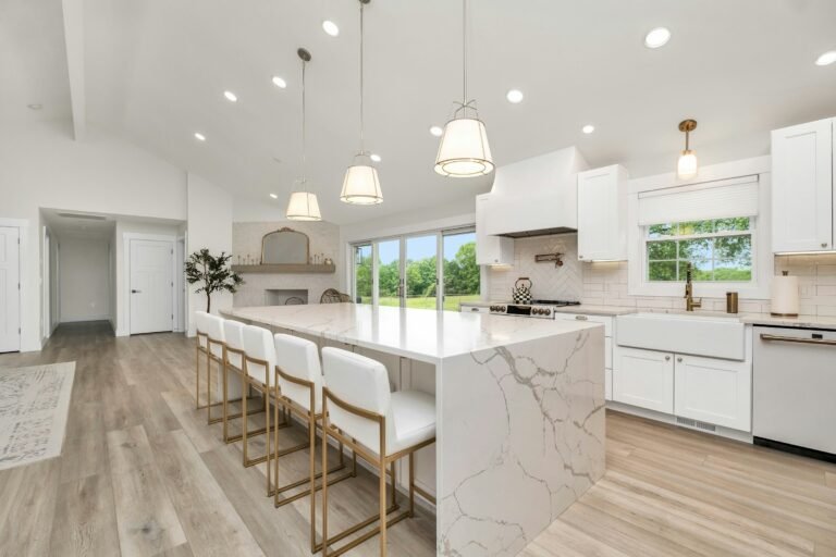 White kitchen with a marble island