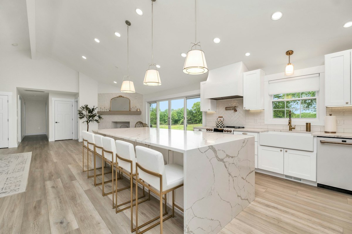 White kitchen with a marble island