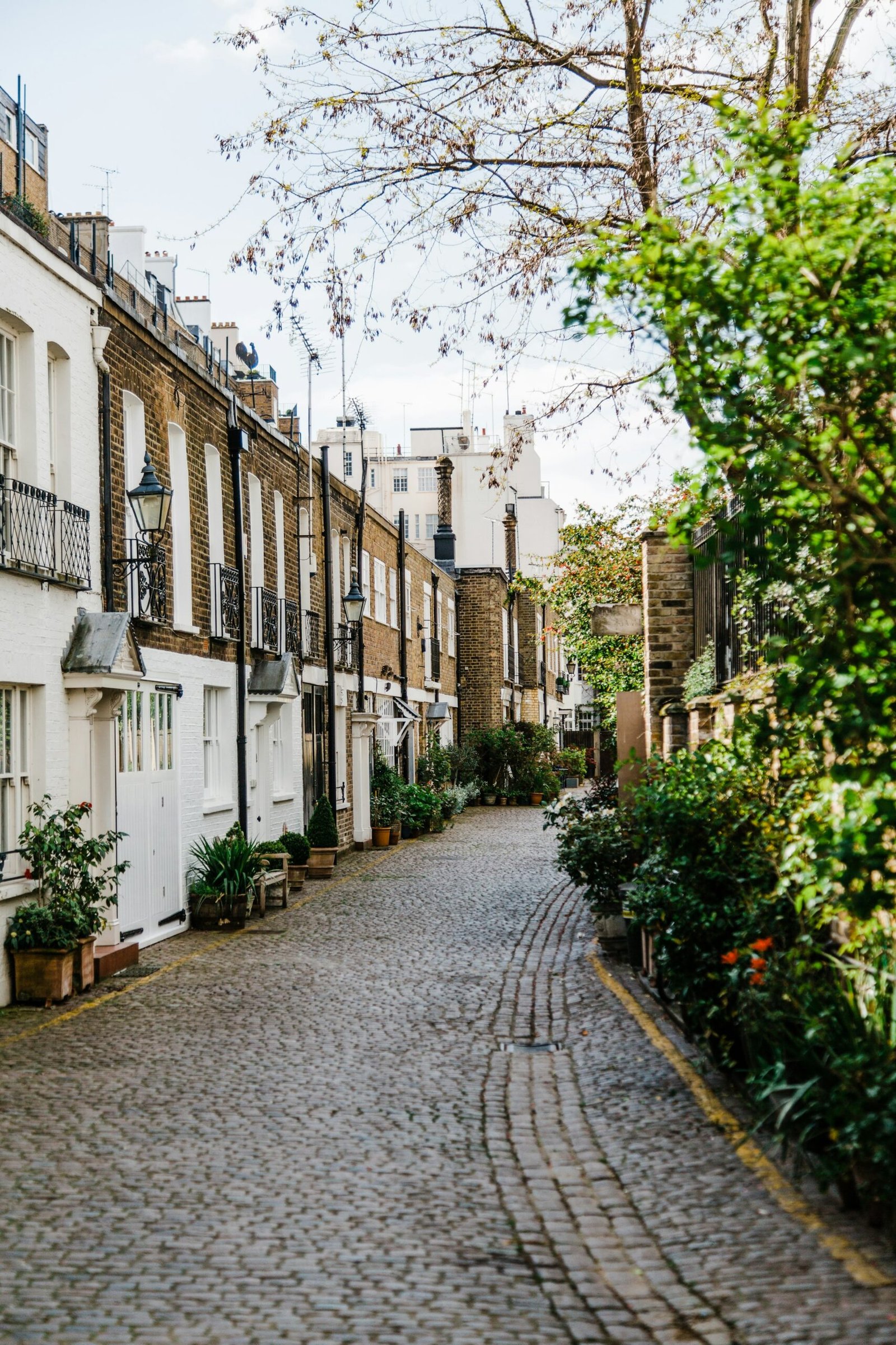 Cobblestone street of white and brick houses in Kynance Mews, London