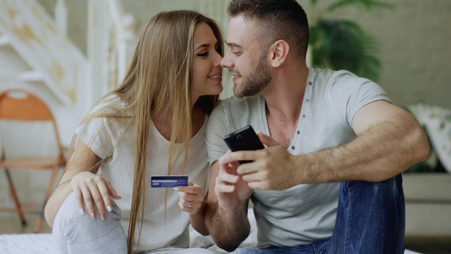 Couple holding a credit card and phone