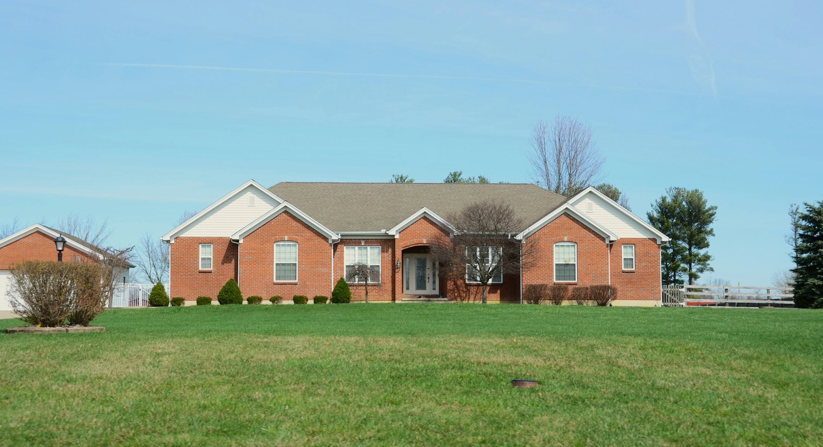 Large brick house with a manicured lawn