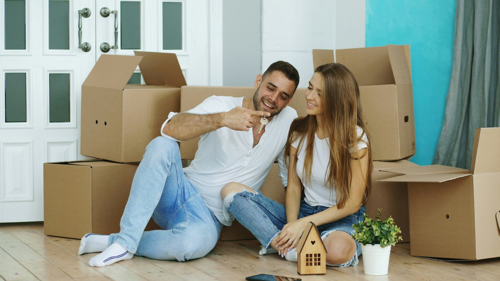 Couple sitting among moving boxes in a new home