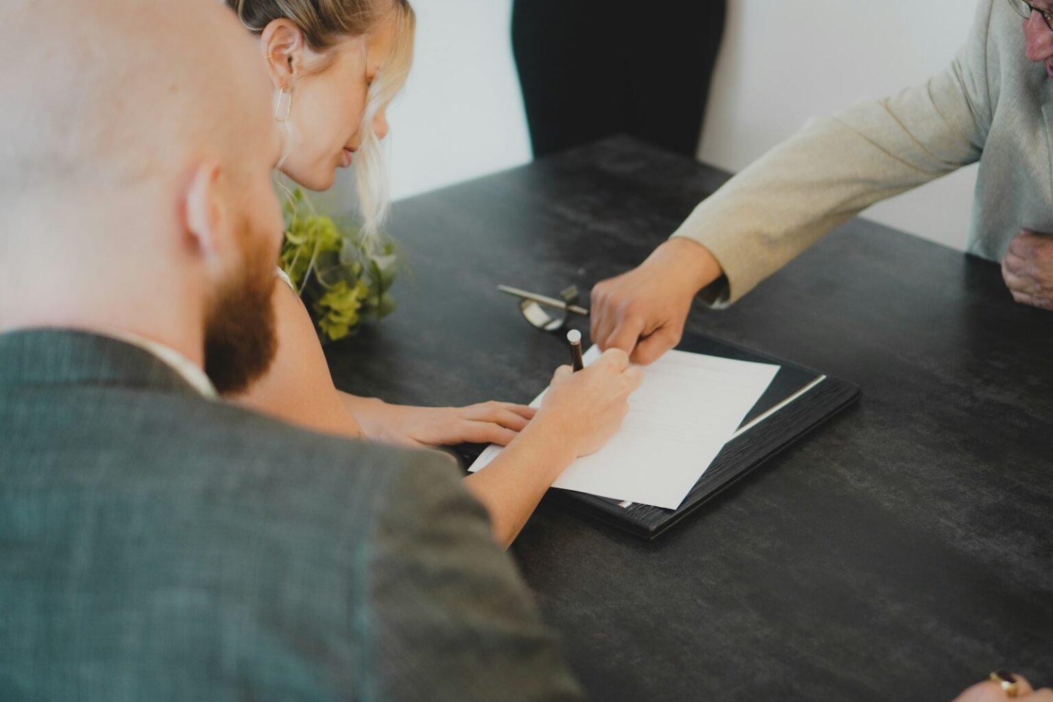 Couple signing documents at a desk