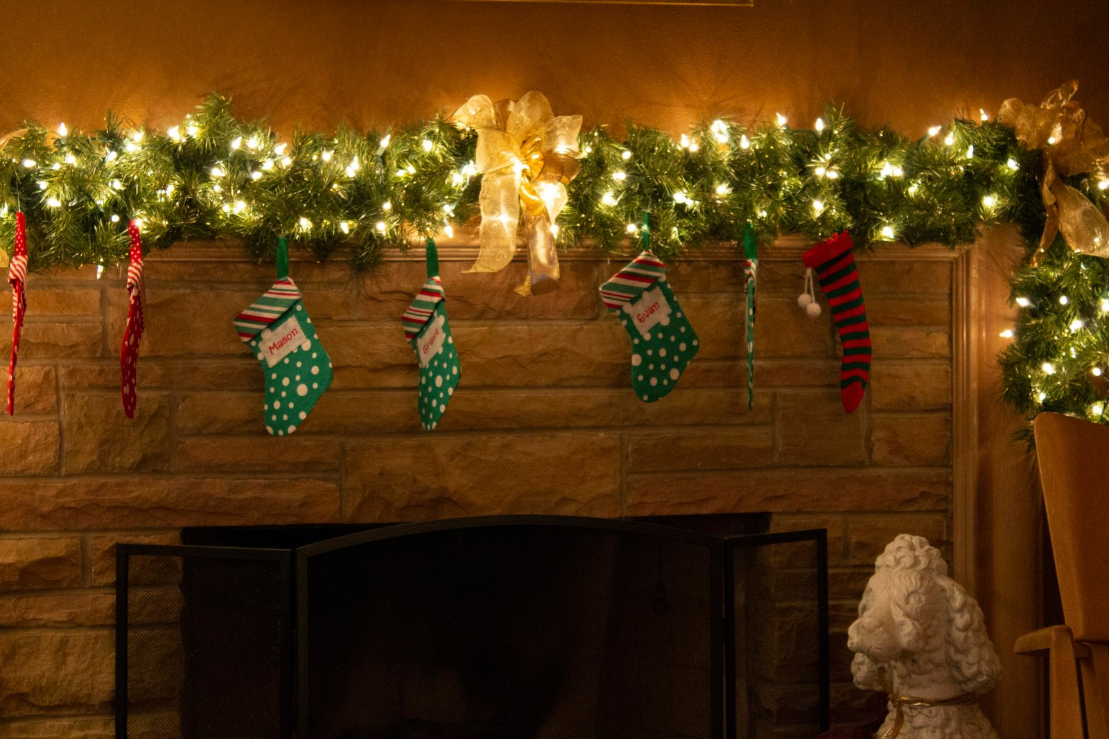 String lights and Christmas stockings on a wall
