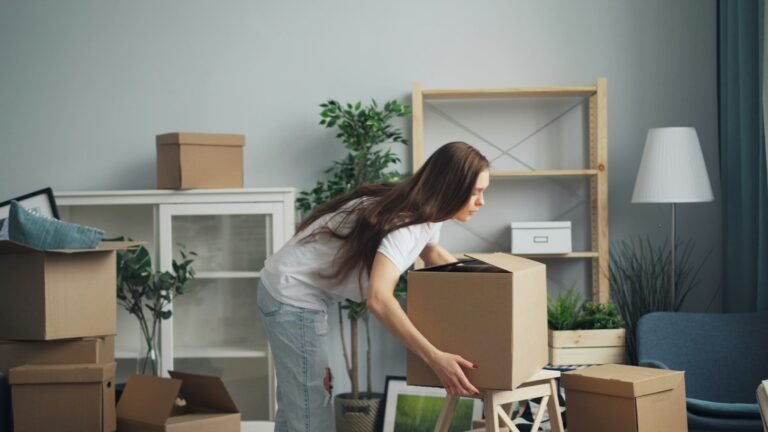 Person moving boxes in a living room