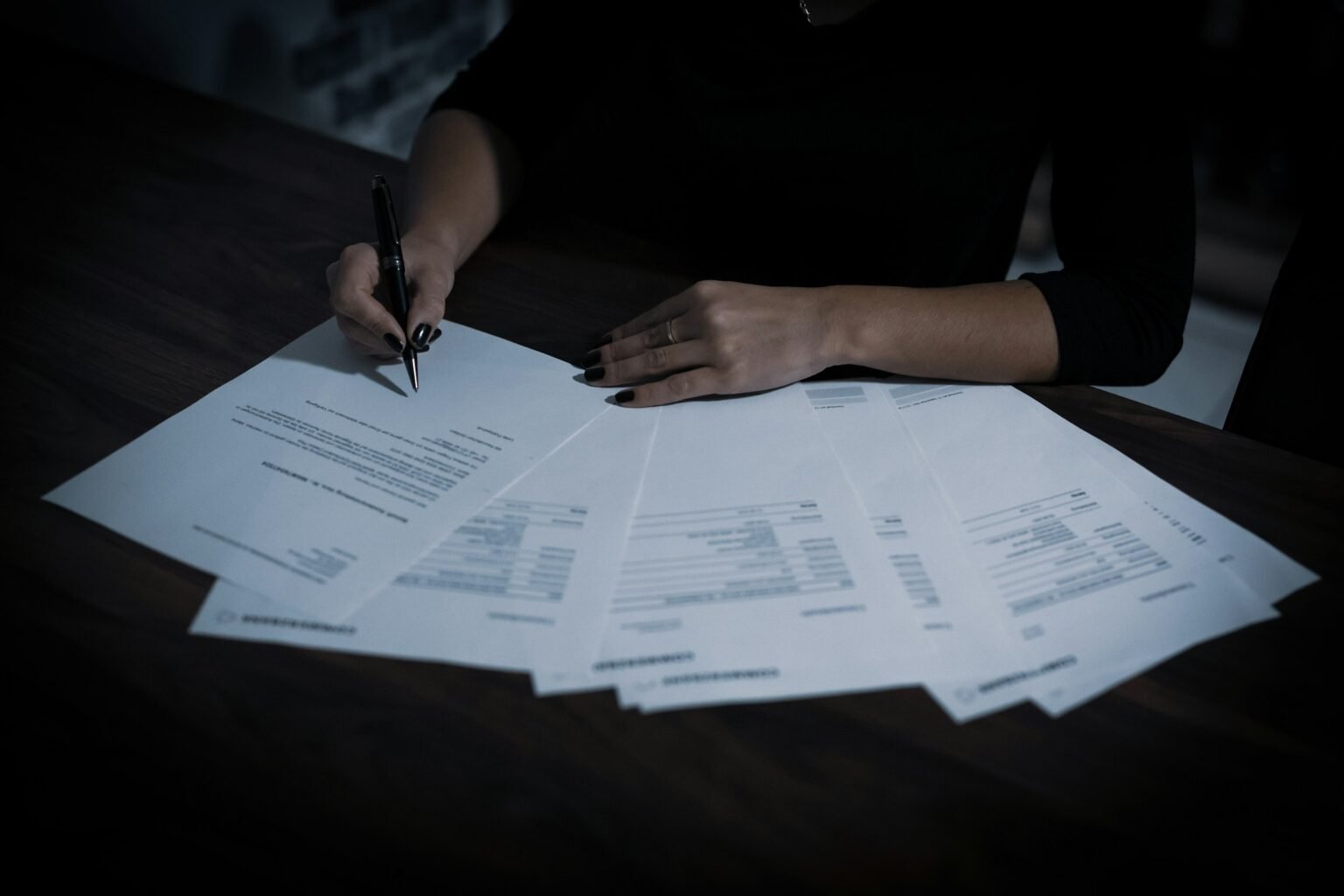 Woman sitting at a table with papers