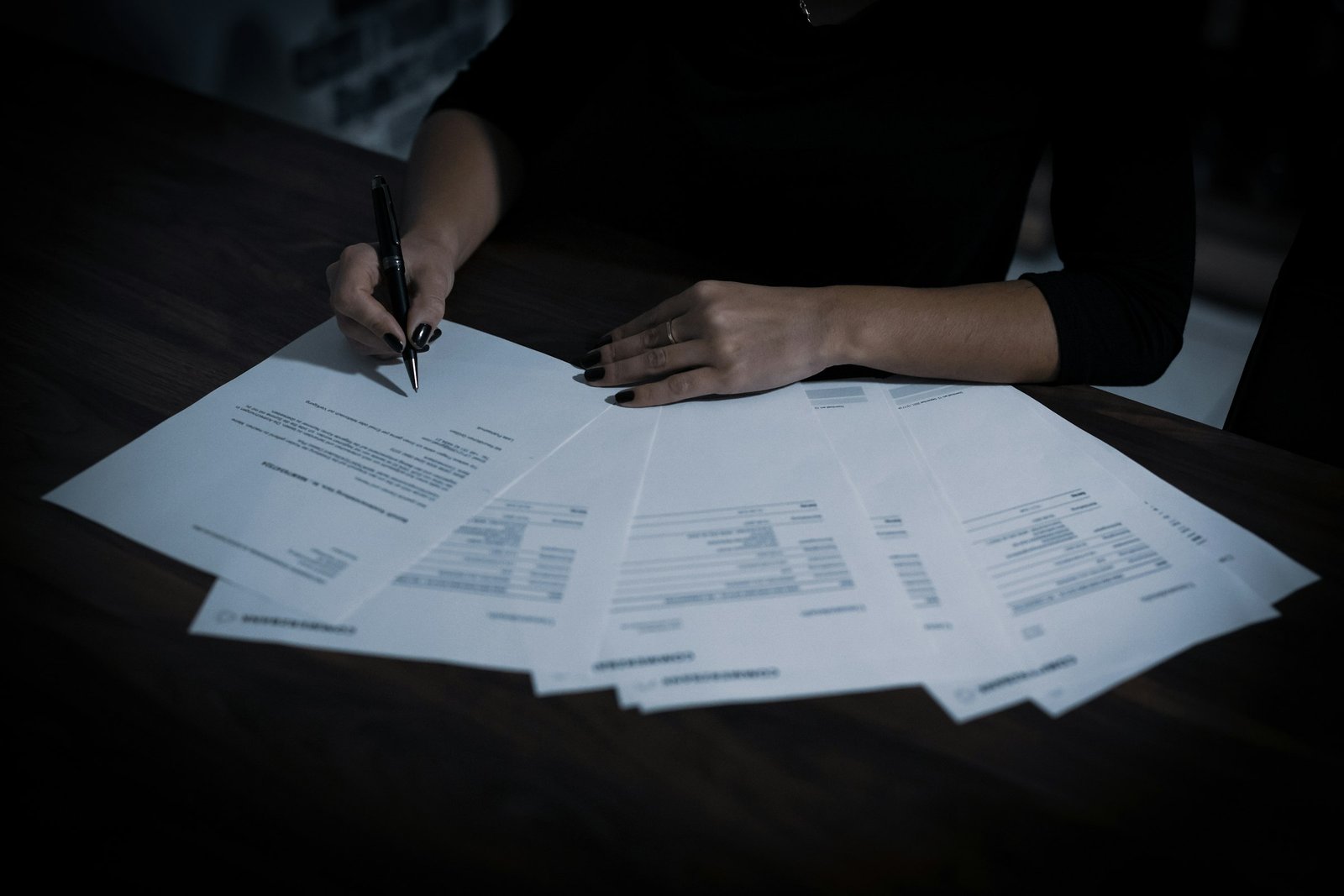 Woman sitting at a table with papers