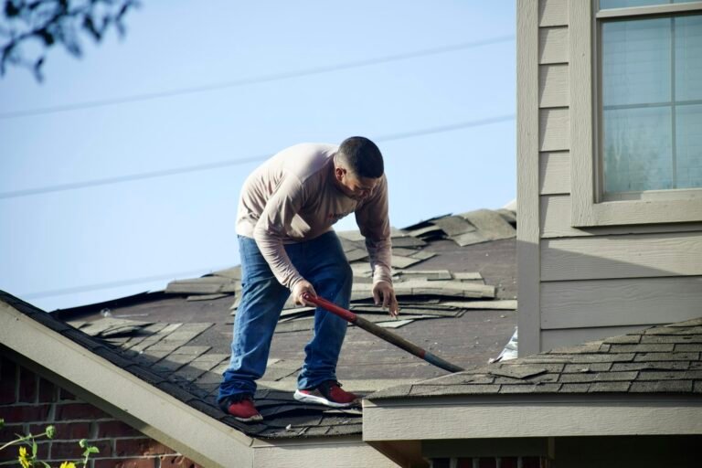 Roofer working on an asphalt shingle roof