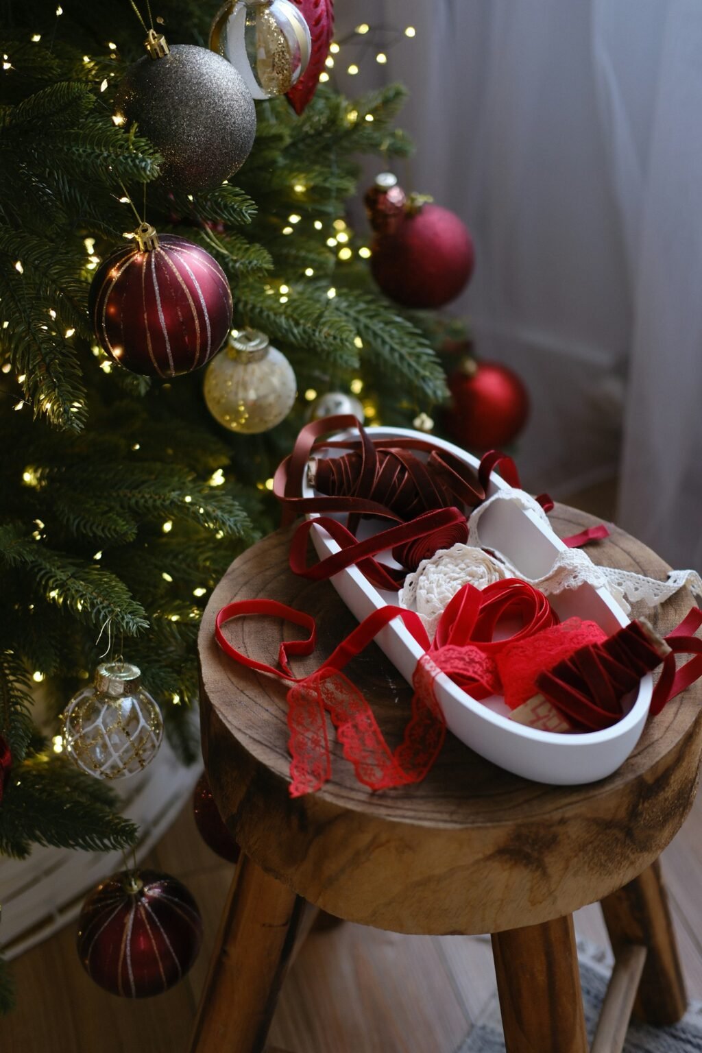 Christmas decorations and ribbon on a wooden stool