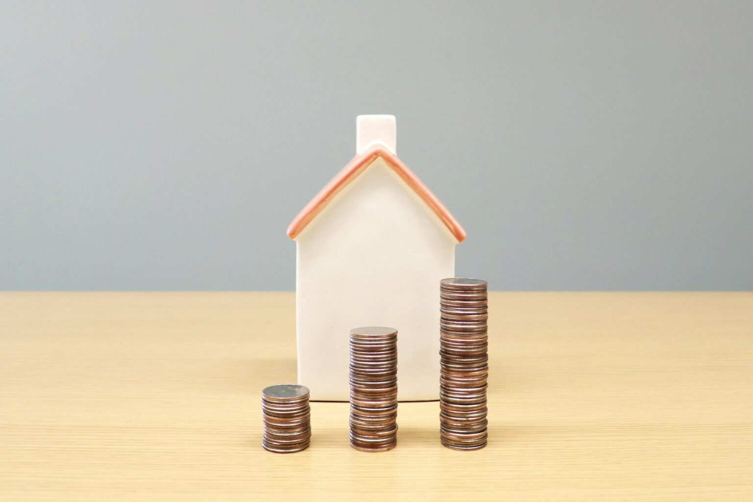 House model and stacks of coins