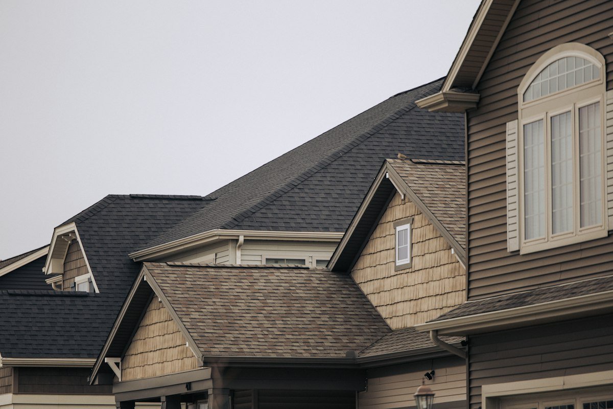 Houses with brown asphalt shingle roofs