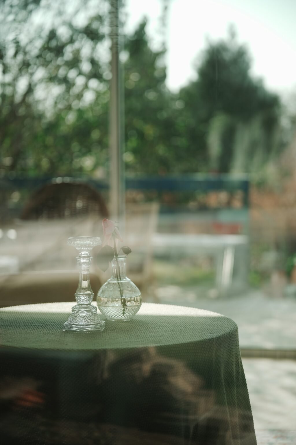 Candlestick and vase by a window