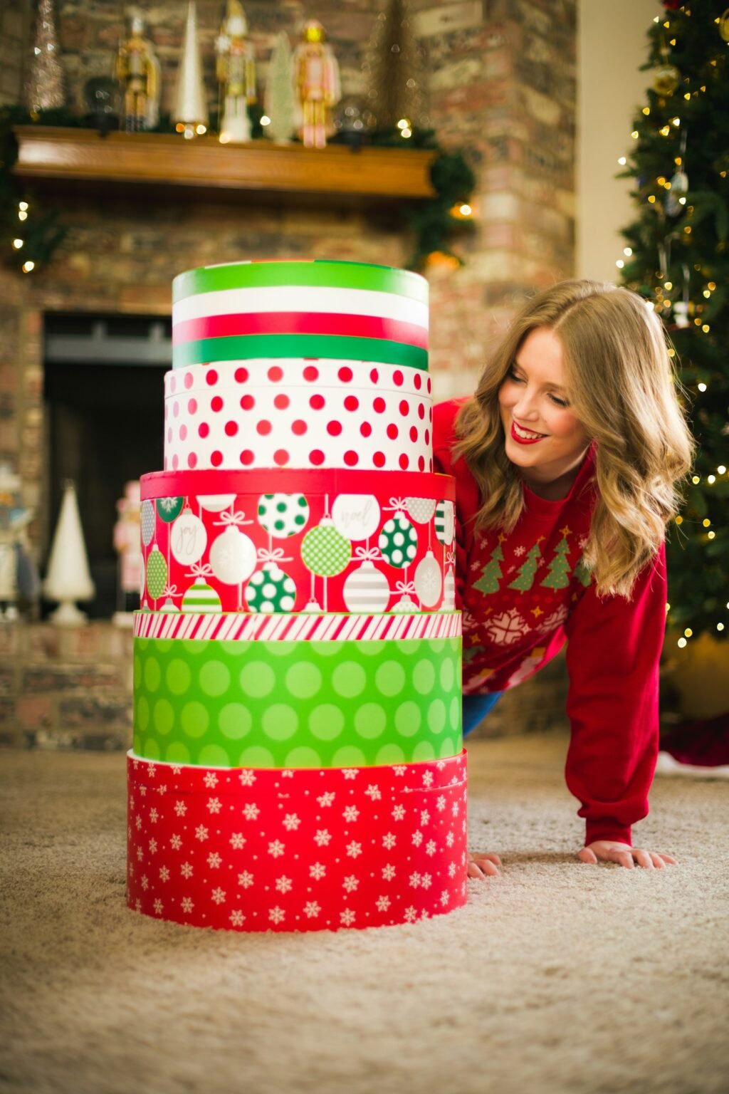 Woman leaning over a stack of Christmas presents