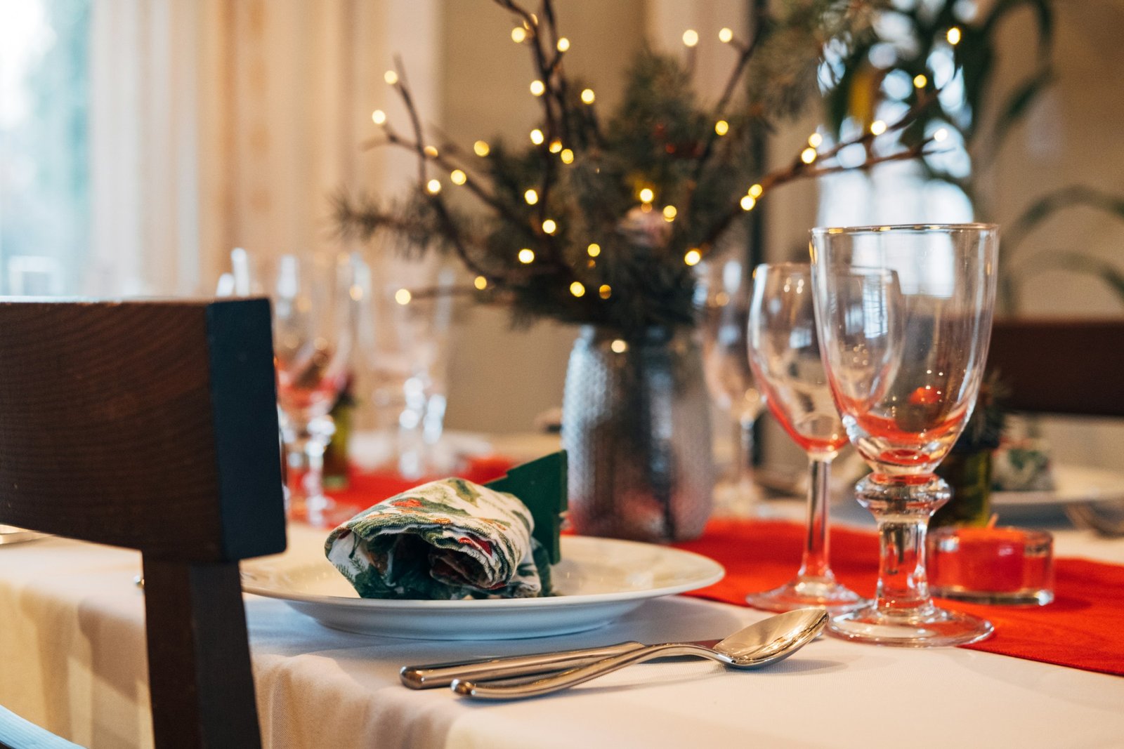 Table set for a holiday dinner with wine glasses