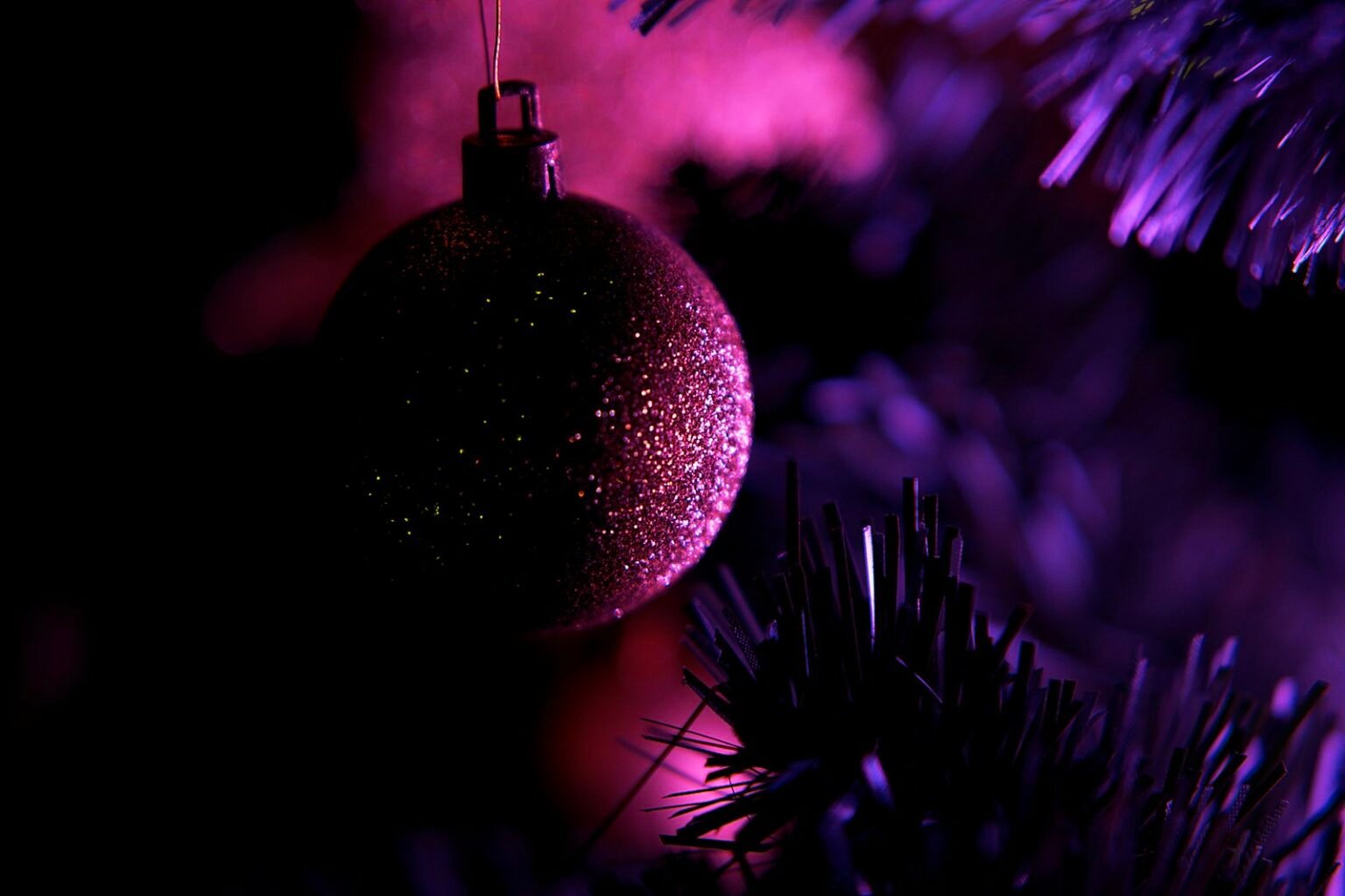 Purple ornament hanging on a Christmas tree