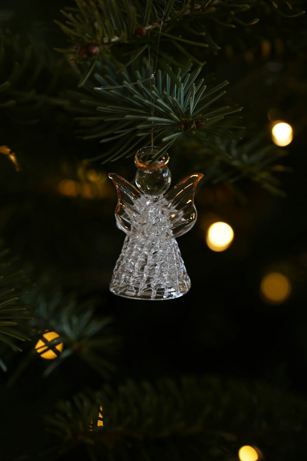 Glass angel ornament on a Christmas tree