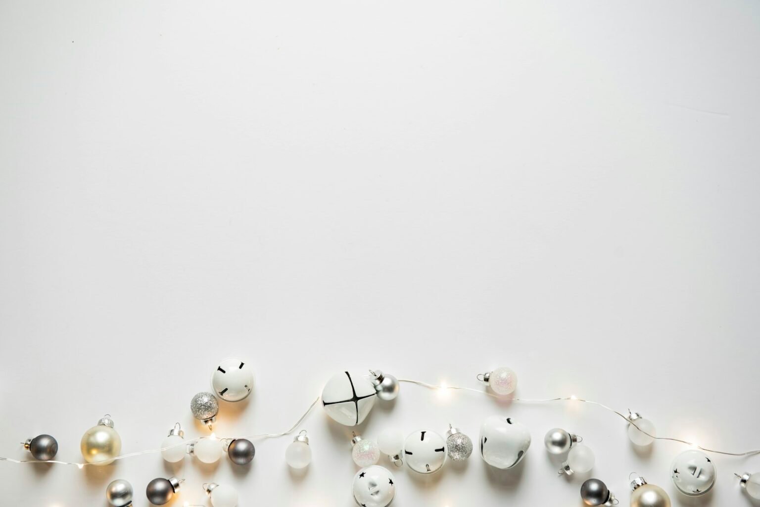 White and silver Christmas ornaments with fairy lights
