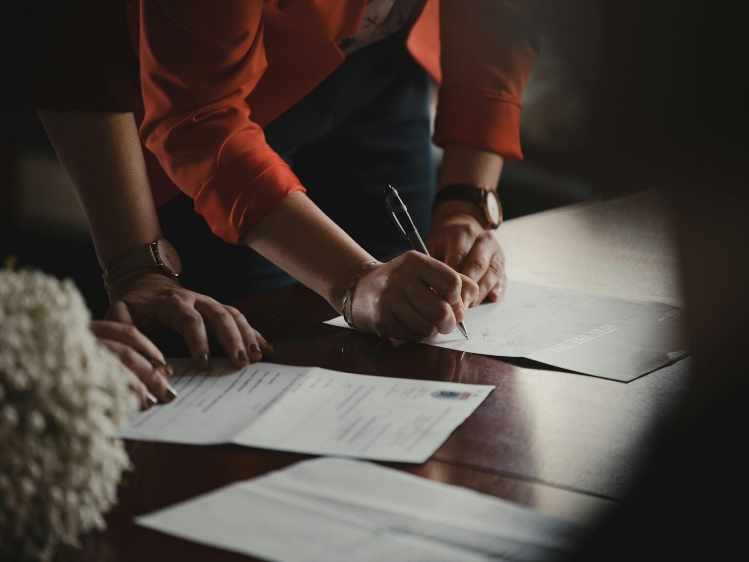 Person writing on a document