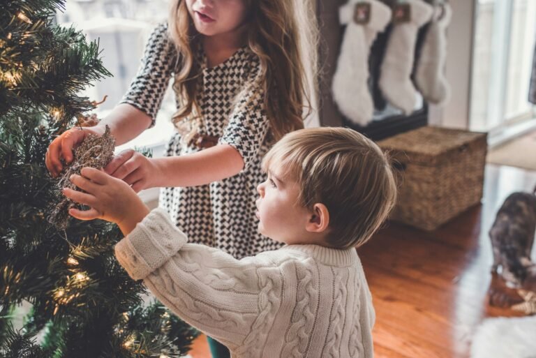 Boy and girl decorating a Christmas tree