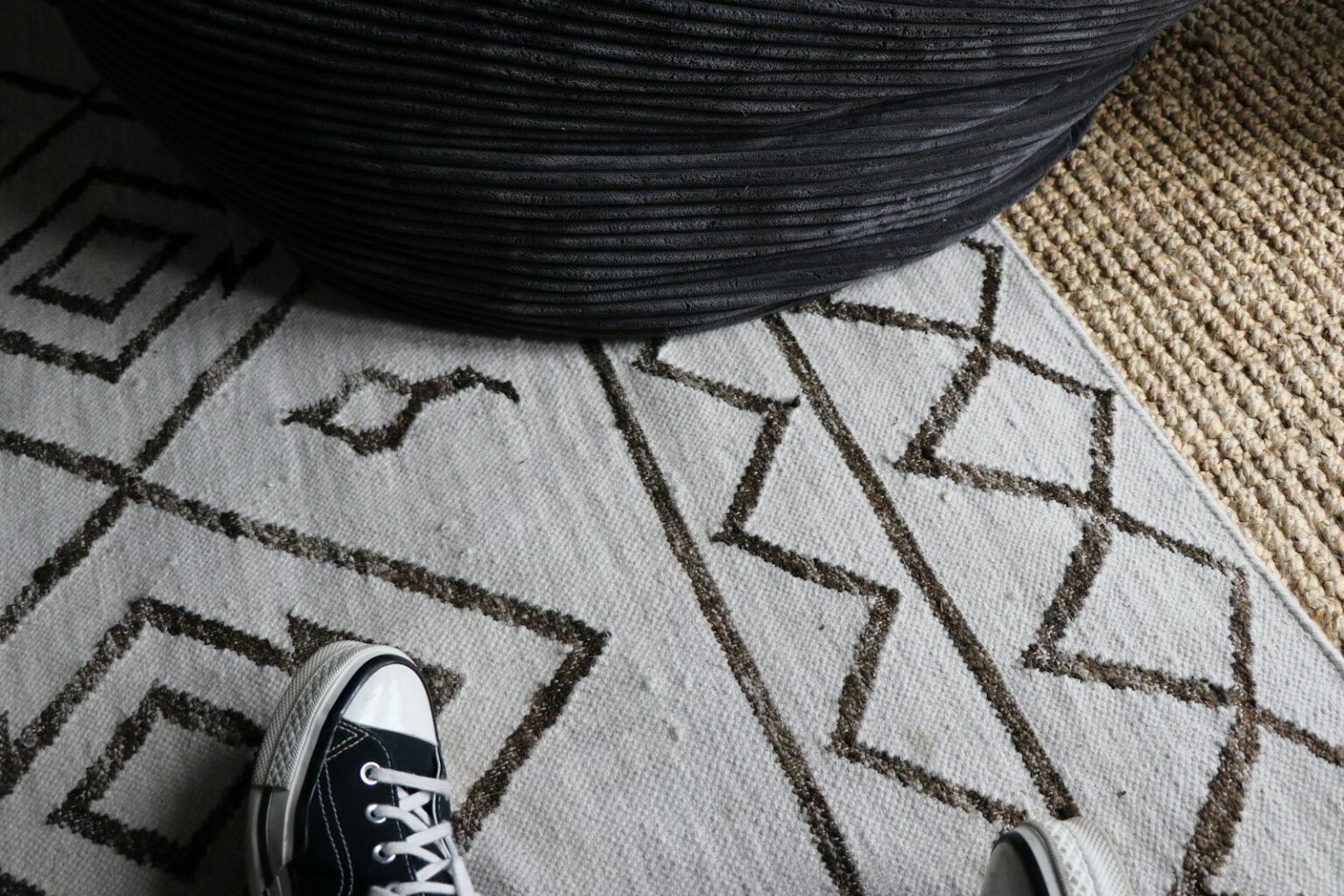 Sneakers on a geometric patterned rug