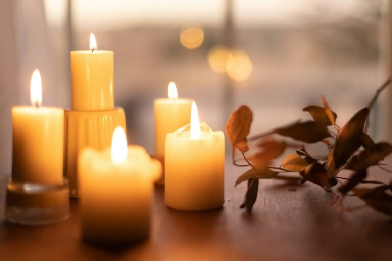 Unscented pillar candles style idea: white pillars on a wooden table