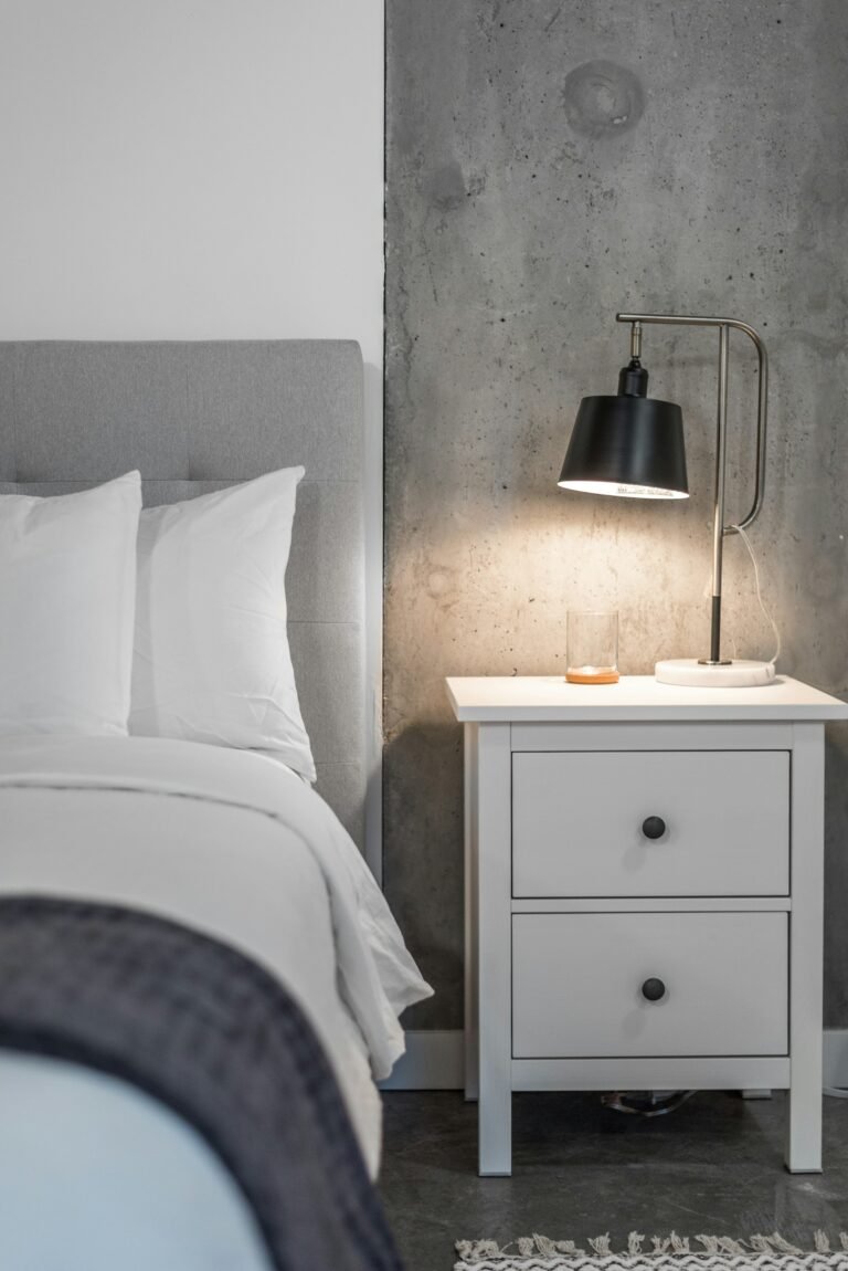 Bedroom with a small end table used as a nightstand beside the bed