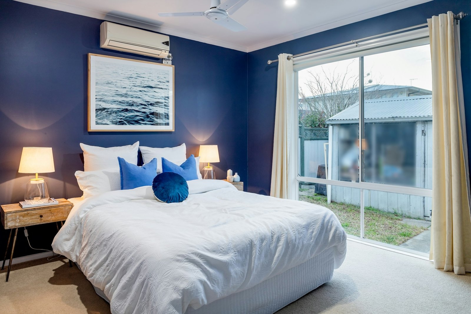 Velvet blackout curtains mood: a bedroom with blue walls and a white bed