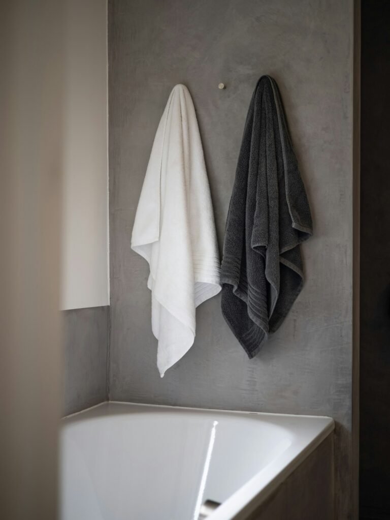 Soft towels on a tub that pair well with a waffle bath mat