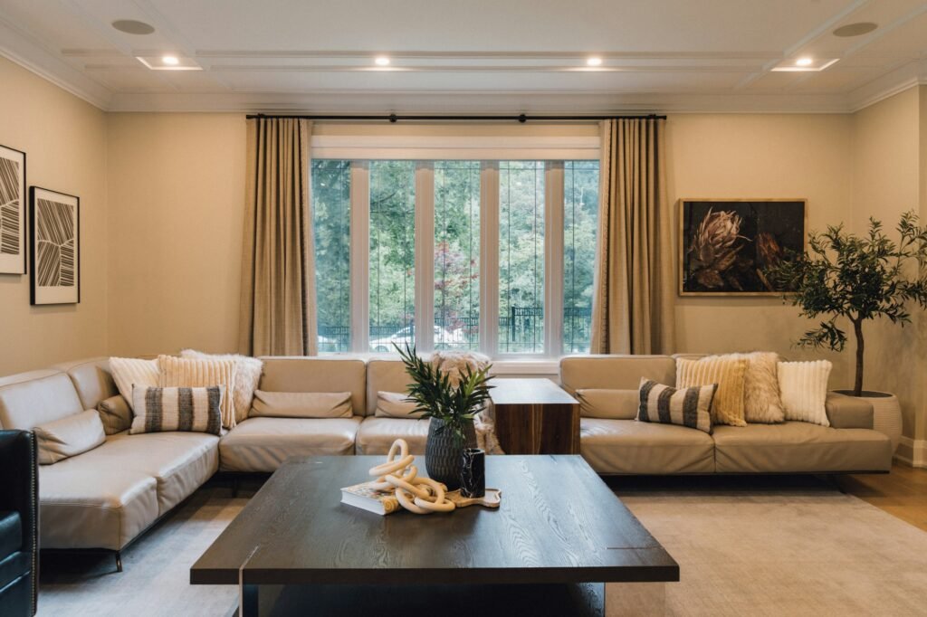 Linen curtains for living room windows: floor-length panels on a wide rod framing tall windows