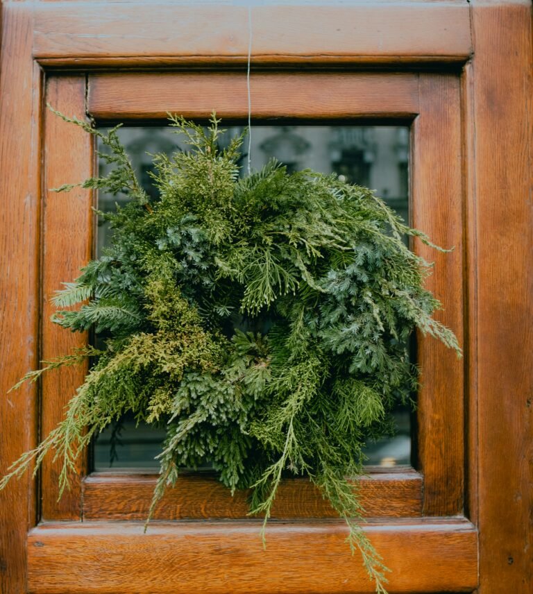 Wood home sign idea: green eucalyptus wreath on a wooden door