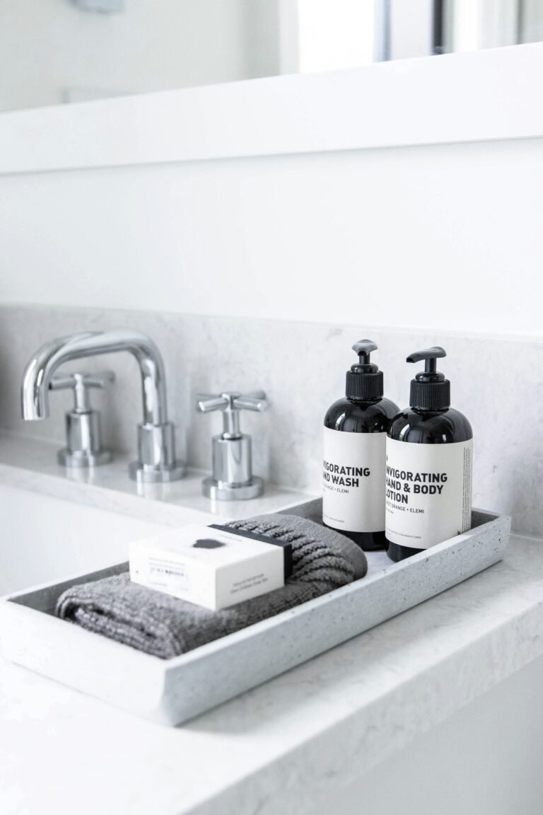 Bathroom sink with soap bottles ready for a wooden soap tray